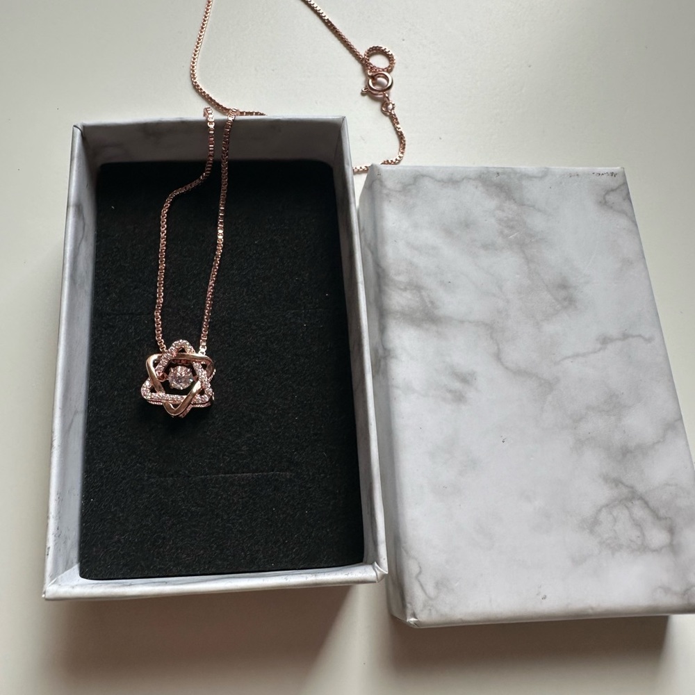 rose gold necklace with gem in the middle